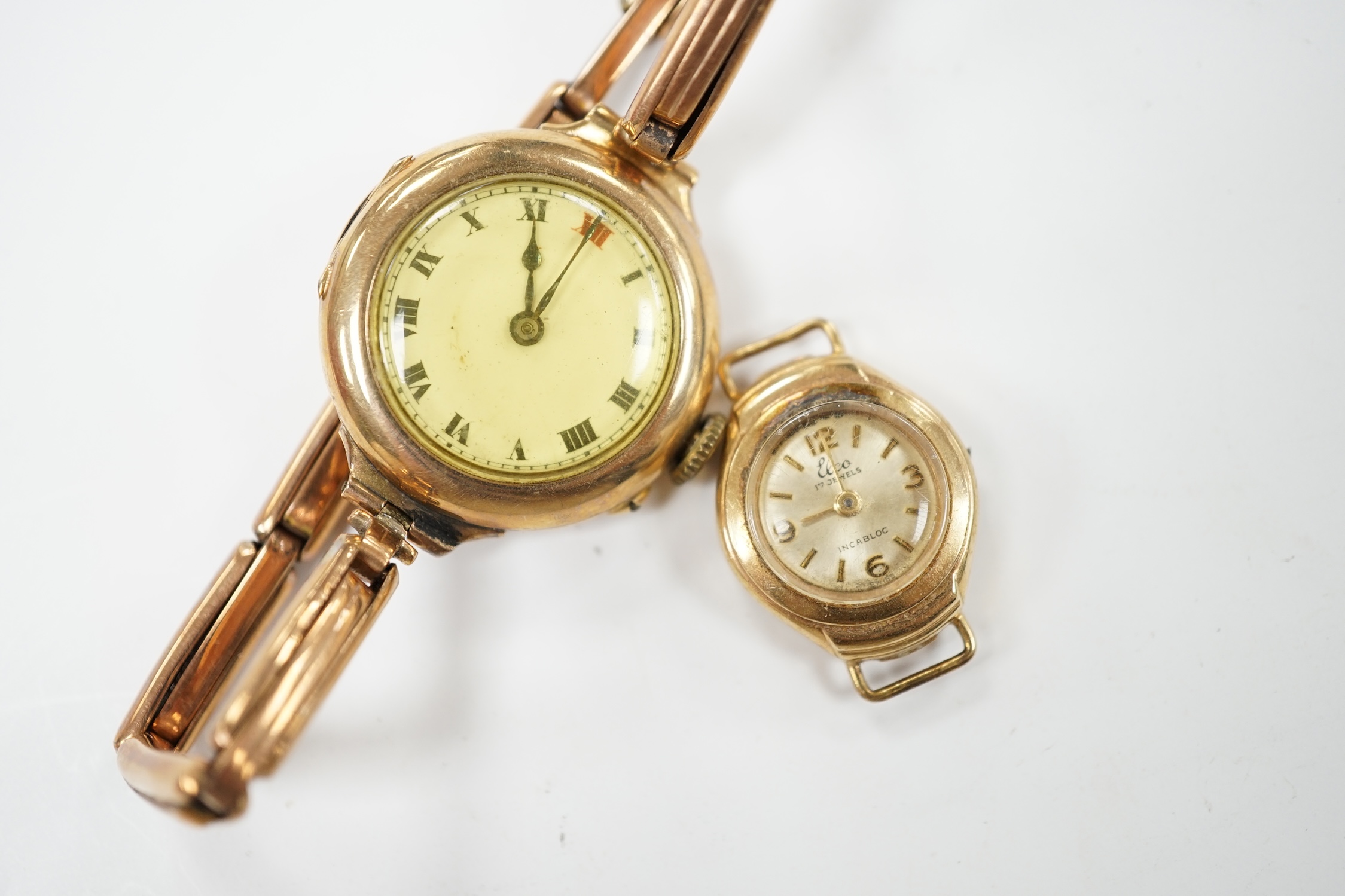 A lady's early 20th century 9ct gold manual wind wrist watch, on a 9ct expanding bracelet, gross weight 19.4 grams, together with a lady's 9ct gold Elco watch. Condition - poor